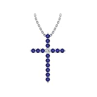 14k White Gold timeless cross pendant set with 15 celestial blue sapphires (1/2ct, AA Quality) encompassing 1 round white diamond, (.045ct, H-I Color, I1 Clarity), suspended on a 18