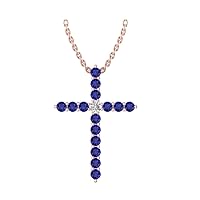14k Rose Gold timeless cross pendant set with 15 celestial blue sapphires (1/2ct, AA Quality) encompassing 1 round white diamond, (.045ct, H-I Color, I1 Clarity), suspended on a 18