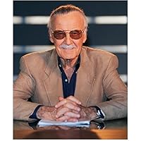 Stan Lee 8 Inch x10 Inch Photo Writer Producer Actor Iron Man Spider-Man Seated Wearing Tan Jacket Over Navy Blue Shirt Pose 2 kn