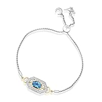 Jewelili Enchanted Disney Fine Jewelry Sterling Silver and 10K Yellow Gold 8x6 MM Oval and 1.1 MM Round Cut Swiss Blue Topaz with 1/5 Cttw Natural White Round Diamonds Jasmine Bracelet