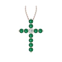 14k Rose Gold timeless cross pendant set with 10 beautiful green emeralds (1/5ct, AA Quality) encompassing 1 round white diamond, (.055ct, H-I Color, I1 Clarity), dangling on a 18