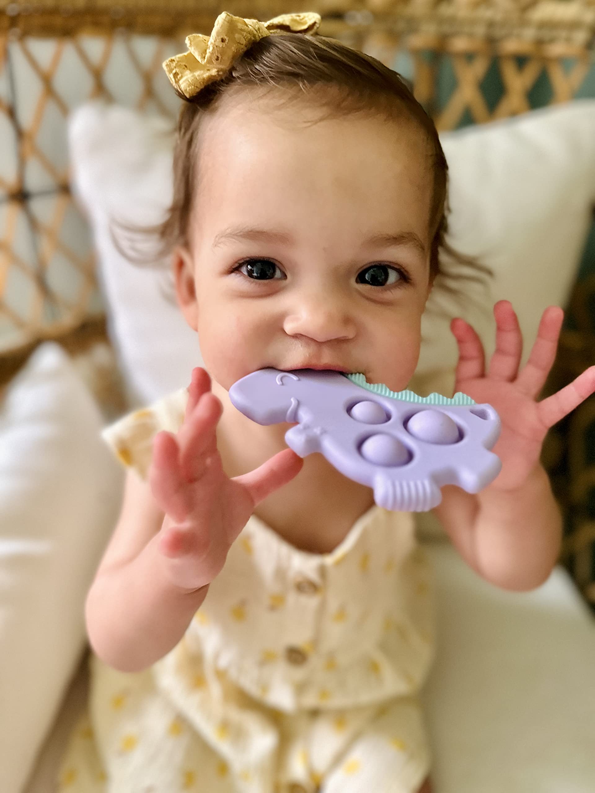 Itzy Ritzy Sensory Popper Toy - Itzy Pop Toy Features Raised Textures to Soothe Sore Gums; Relieves Stress and Improves Fine Motor Skills; Can Attach to a Bag or Pacifier Strap; Lilac Dinosaur