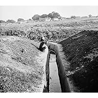 India Malaria Prevention Na Boy Seated Near An Irrigation Ditch In India Lined With Concrete To Deter Malaria Mosquitos Photograph C1929 Poster Print by (18 x 24)