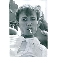 Vintage photo of A Vietnamese man smoking a cigarette. 1968.