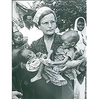 Vintage photo of Kids suffering from malnutrition while woman carrying them in Biafra.