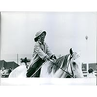 Vintage photo of Princess Yasmin Aga Khan having fun while riding the horse.