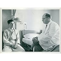 Vintage photo of A doctor is talking to his patient in a serious manner and conversing what his disease and medications about.