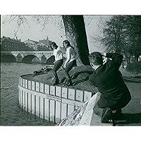 Vintage photo of A man taking a picture of Mia and Pia Genberg, standing on the edge by the lake.
