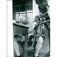 Vintage photo of Doctor examining a malnourished boy in Congo.The Congo Crisis was a period of political upheaval and conflict in the Republic of the Congo (today the Democratic Republic of the Congo)[c] between 1960 and 1965.