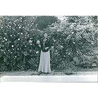 Vintage photo of A view of Princess Soraya of Iran, standing by the pool area.